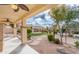View of a backyard with a covered patio, gravel landscaping, an artificial lawn, and a pergola at 32160 N Dog Leg Ct, San Tan Valley, AZ 85143