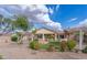 Backyard with desert landscaping, artificial grass, shade structures, and well-maintained bushes at 32160 N Dog Leg Ct, San Tan Valley, AZ 85143