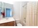 Cozy bathroom featuring a shower with curtain, a toilet and a vanity with mirror and overhead light at 32160 N Dog Leg Ct, San Tan Valley, AZ 85143