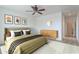 Well-lit bedroom showcases neutral decor, modern furniture, and a ceiling fan, creating a serene and stylish retreat at 32160 N Dog Leg Ct, San Tan Valley, AZ 85143