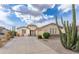 Charming single-story home features desert landscaping and a spacious driveway, perfect for suburban living at 32160 N Dog Leg Ct, San Tan Valley, AZ 85143
