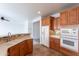Well-designed kitchen offers warm wood cabinetry, modern appliances, and tiled floors for efficient cooking at 32160 N Dog Leg Ct, San Tan Valley, AZ 85143