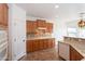 Functional kitchen equipped with wood cabinetry, sleek countertops, and modern appliances for an ideal cooking space at 32160 N Dog Leg Ct, San Tan Valley, AZ 85143