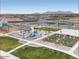 Aerial view of the park with a covered picnic area, playground and bocce ball courts in a new community at 36971 W Santa Maria St, Maricopa, AZ 85138