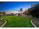 The expansive backyard features lush lawn, landscaping, gazebo, and pool at 3744 E Evans Dr, Phoenix, AZ 85032