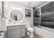 This bathroom offers a vanity, toilet, shower-tub combo with glass doors and tile accent wall at 3744 E Evans Dr, Phoenix, AZ 85032