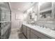 Bathroom featuring double sinks, modern vanity, and a glass-enclosed shower at 3744 E Evans Dr, Phoenix, AZ 85032