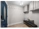 Welcoming entryway featuring wood-look tile floors, a blue door, a bench, and storage cabinets at 3744 E Evans Dr, Phoenix, AZ 85032
