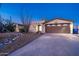 Inviting single-story home with desert landscaping, a two-car garage, and an arched entryway at 3744 E Evans Dr, Phoenix, AZ 85032
