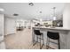 Open kitchen features a breakfast bar with barstool seating, pendant lights, and modern finishes at 3744 E Evans Dr, Phoenix, AZ 85032