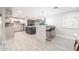 Modern kitchen with a large island, stainless steel appliances, stylish backsplash, and tile floors at 3744 E Evans Dr, Phoenix, AZ 85032