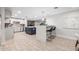 Bright, open kitchen with a blue island, stylish pendant lighting, and views of the outside at 3744 E Evans Dr, Phoenix, AZ 85032