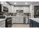 Kitchen with stainless steel appliances and modern backsplash at 3744 E Evans Dr, Phoenix, AZ 85032