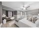 Well-lit primary bedroom with a ceiling fan and a seating area with a day bed at 3744 E Evans Dr, Phoenix, AZ 85032