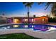 Backyard pool at dusk with lush landscaping, palm trees, and patio at 3744 E Evans Dr, Phoenix, AZ 85032