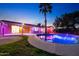 Backyard pool features lighting, palm tree, and patio area at 3744 E Evans Dr, Phoenix, AZ 85032