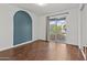 Bedroom with wood floors, blue accent wall, sliding glass doors leading to balcony with outdoor seating at 3845 E Greenway Rd # 230, Phoenix, AZ 85032