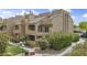 Exterior view showcasing the architectural style of the multi-story complex surrounded by lush greenery at 3845 E Greenway Rd # 230, Phoenix, AZ 85032