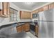 Well-equipped kitchen features stainless steel appliances, dark countertops, and ample wood cabinetry at 3845 E Greenway Rd # 230, Phoenix, AZ 85032