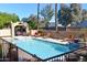 Community swimming pool featuring lounge chairs and covered grilling area at 3845 E Greenway Rd # 230, Phoenix, AZ 85032