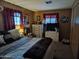 Cozy bedroom features wood paneling, large window, and dresser with mirror at 44 S Hawes Rd # B7, Mesa, AZ 85208