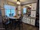 Cozy dining area with round table, comfortable seating, and built-in cabinets at 44 S Hawes Rd # B7, Mesa, AZ 85208
