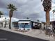 Charming home with palm trees, a covered carport, and well-maintained landscaping at 44 S Hawes Rd # B7, Mesa, AZ 85208