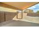 This backyard features a brick wall and view of the covered patio with home exterior at 4613 W Ellis St, Laveen, AZ 85339
