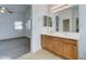 Primary bathroom with dual sinks and carpeted floors at 4613 W Ellis St, Laveen, AZ 85339