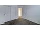 This bedroom is shown with carpet, neutral walls, a closet and an opened door at 4613 W Ellis St, Laveen, AZ 85339