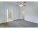 Bedroom featuring carpet, neutral walls, and a ceiling fan with view to Primary bath at 4613 W Ellis St, Laveen, AZ 85339