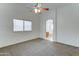 Bedroom featuring carpet, neutral walls, and a ceiling fan with view to bathroom at 4613 W Ellis St, Laveen, AZ 85339