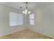 Bright and airy dining room with neutral tile floors and a chandelier at 4613 W Ellis St, Laveen, AZ 85339