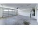 Attached garage featuring a roll up door, ceiling access and hot water heater at 4613 W Ellis St, Laveen, AZ 85339