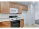 Cozy kitchen with wooden cabinets and white appliances for easy cooking at 4613 W Ellis St, Laveen, AZ 85339