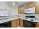Well-lit kitchen with white appliances and wooden cabinets, perfect for any cook at 4613 W Ellis St, Laveen, AZ 85339