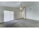 Bright living room with neutral walls, carpet, and a sliding door to the outdoors at 4613 W Ellis St, Laveen, AZ 85339