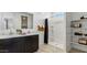 Bathroom featuring a double vanity, walk-in shower, and convenient built-in shelving at 5568 E Rock Bush Ln, San Tan Valley, AZ 85140