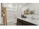 Bright bathroom with white shower-tub combination, marble countertop vanity, decorative wall art, and dark wood cabinetry at 5568 E Rock Bush Ln, San Tan Valley, AZ 85140