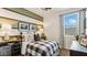 Comfortable bedroom featuring a plaid bedspread, striped accent wall, and natural light at 5568 E Rock Bush Ln, San Tan Valley, AZ 85140