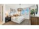 Bright bedroom featuring a statement chandelier, textured wallpaper, and a large window at 5568 E Rock Bush Ln, San Tan Valley, AZ 85140