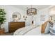 Bedroom featuring a wooden dresser, round mirror, and stylish pendant light fixture at 5568 E Rock Bush Ln, San Tan Valley, AZ 85140