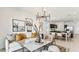 Cozy living room with modern decor, a white sofa, and an adjacent kitchen and dining area at 5568 E Rock Bush Ln, San Tan Valley, AZ 85140
