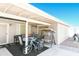 The covered patio has an outdoor dining set and swing, and a view of blue skies at 5735 E Mcdowell Rd # 367, Mesa, AZ 85215