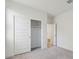A bright bedroom with an open closet, neutral carpet, and white walls at 5742 E Smeaton Pl, San Tan Valley, AZ 85140