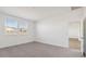 Neutral bedroom with carpet, bright natural light from the windows, and an open door at 5742 E Smeaton Pl, San Tan Valley, AZ 85140