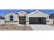 Charming single-story home with a yellow front door, open garage, and low-maintenance desert landscaping at 5742 E Smeaton Pl, San Tan Valley, AZ 85140