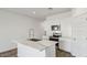 Open-concept kitchen featuring a central island, stainless steel appliances, and modern finishes at 5742 E Smeaton Pl, San Tan Valley, AZ 85140