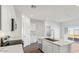 Modern kitchen with white cabinets, stainless steel appliances, and a center island with a sink at 5742 E Smeaton Pl, San Tan Valley, AZ 85140