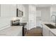 Bright kitchen featuring stainless steel appliances, marble countertops, and wood-look flooring at 5742 E Smeaton Pl, San Tan Valley, AZ 85140